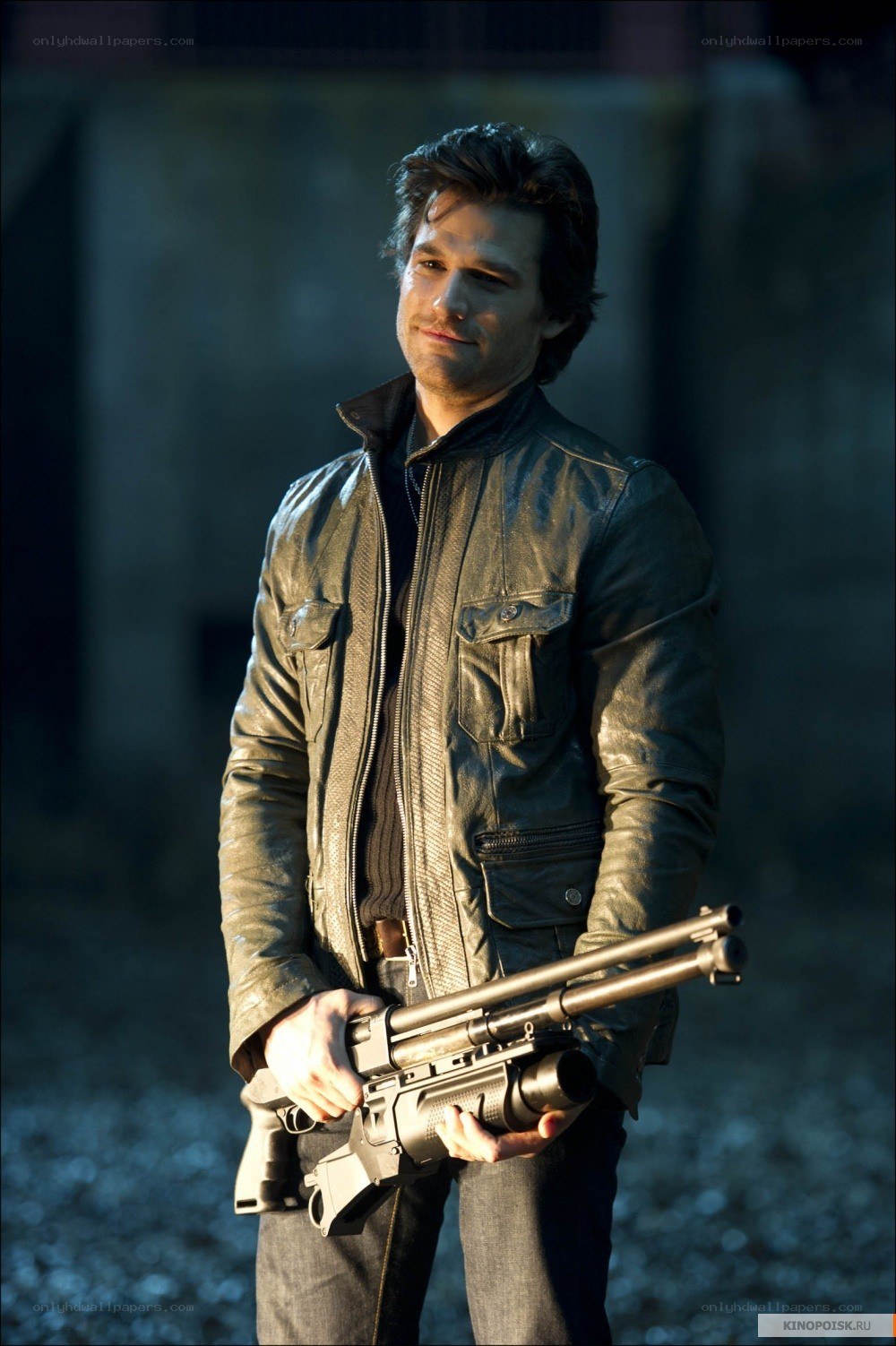man holding a gun in leather jacket