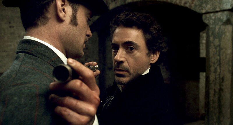 Man holding a gun to another man's head