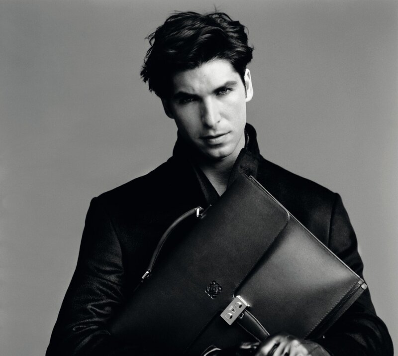man holding a leather bag