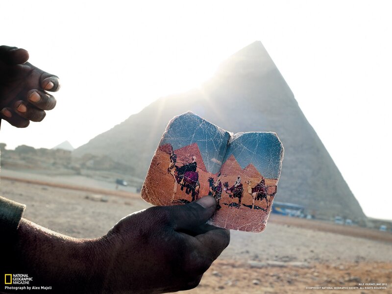 Man holding a photo of pyramids