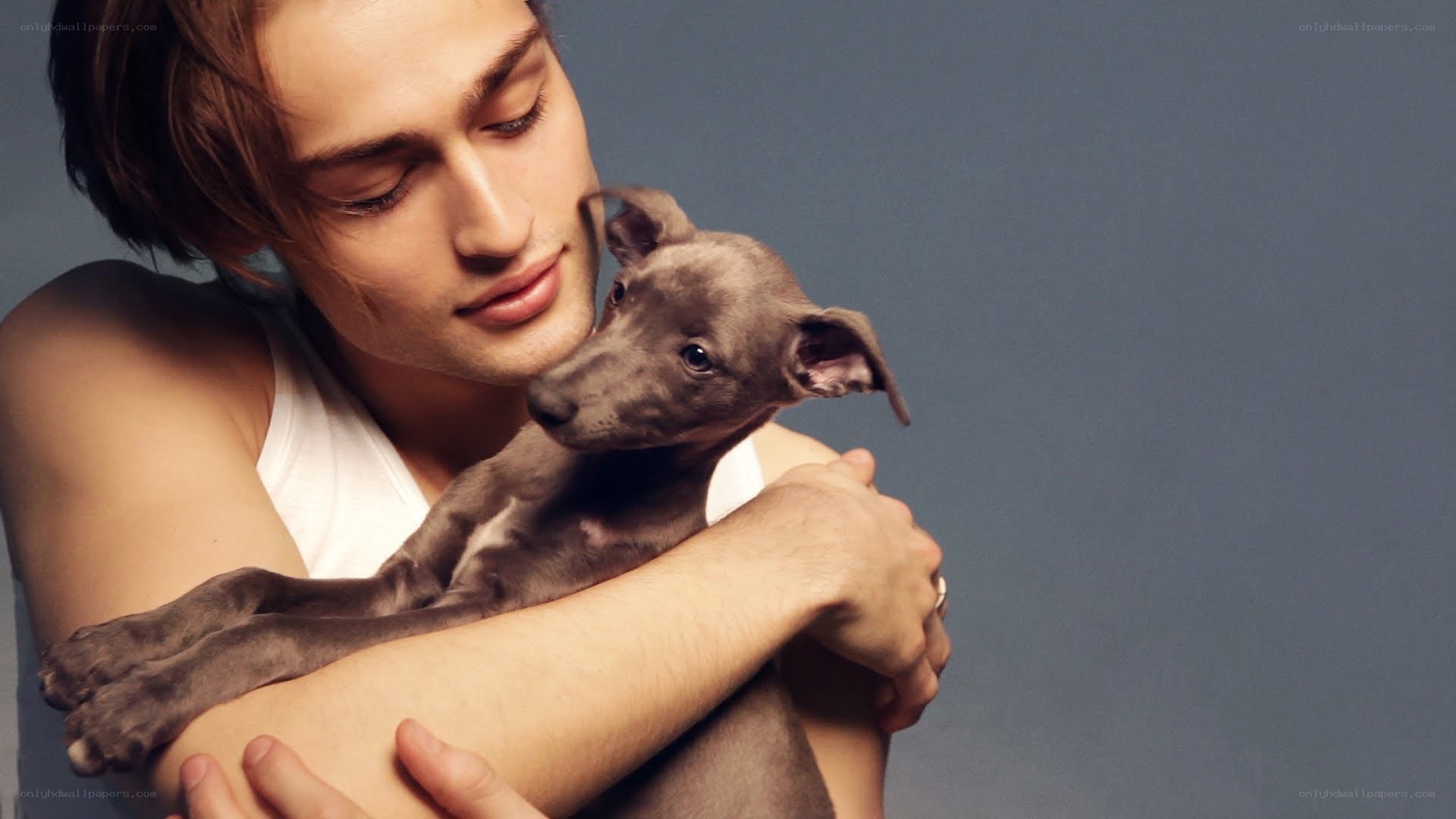 man holding a puppy