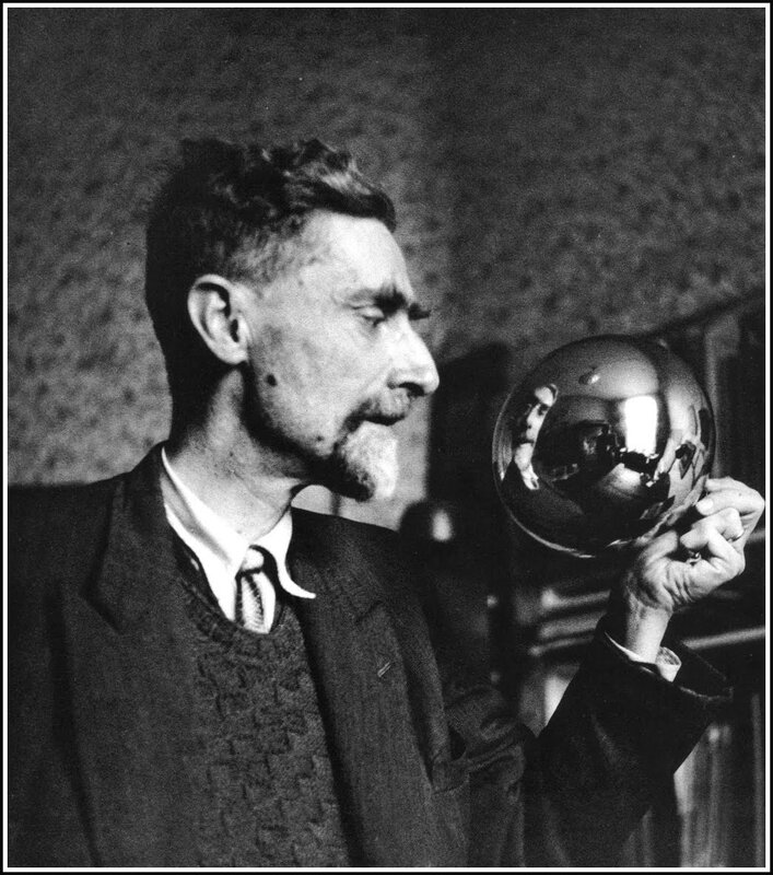 Man holding a reflective sphere