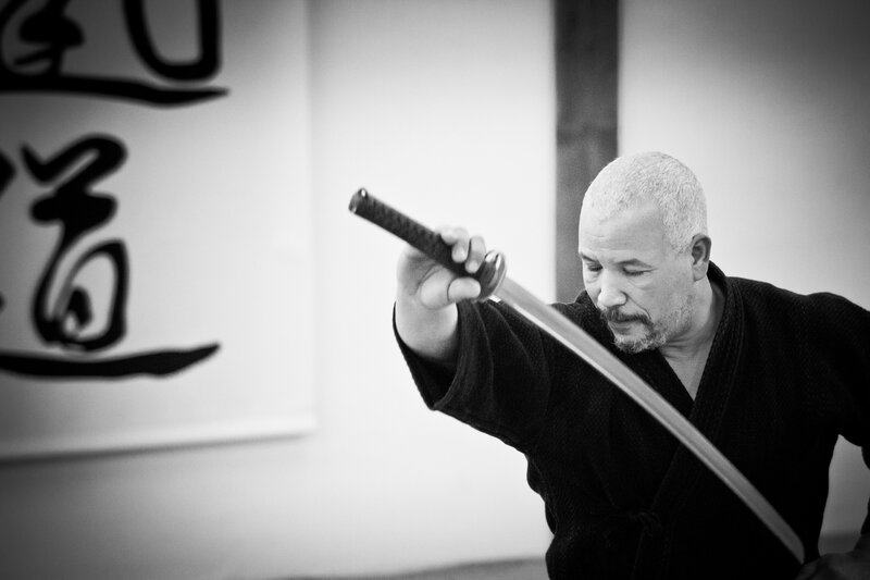 Man Holding a Sword — Black, Focused