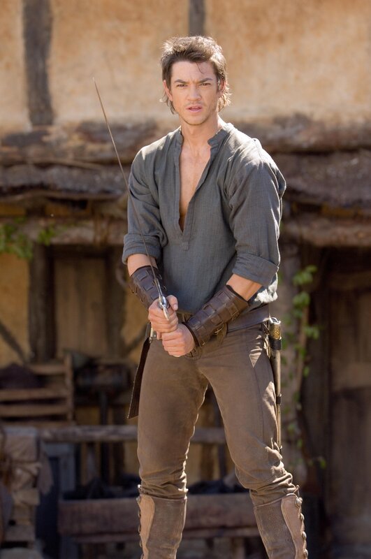 Man holding a sword in medieval attire