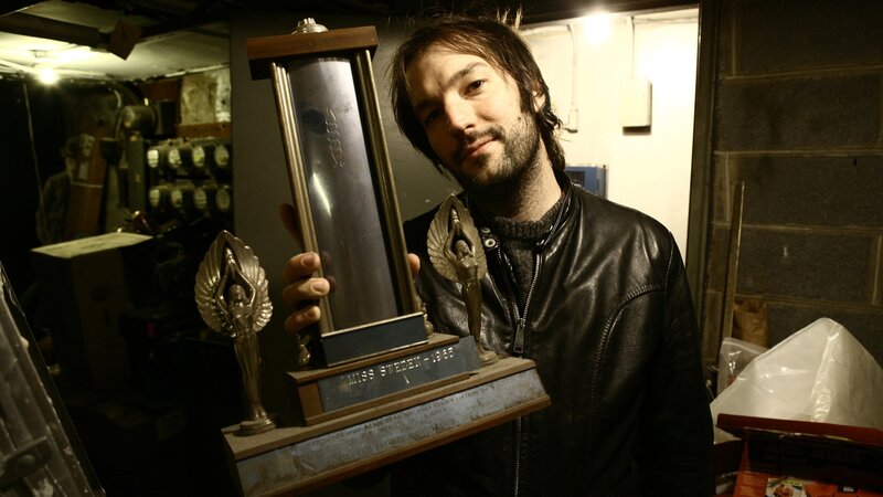 man holding a trophy