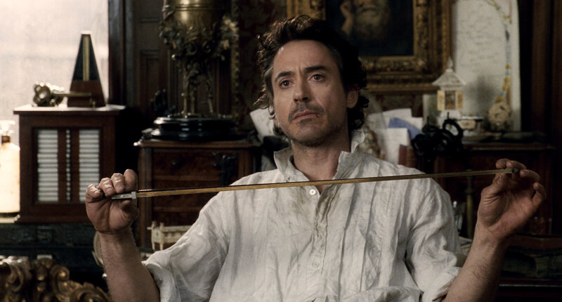 man holding a violin bow