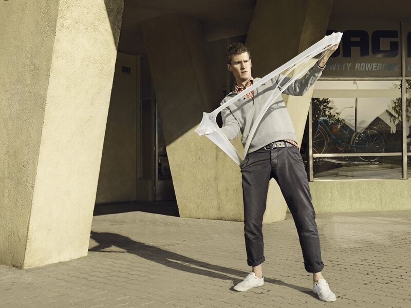 Man holding a white scarf