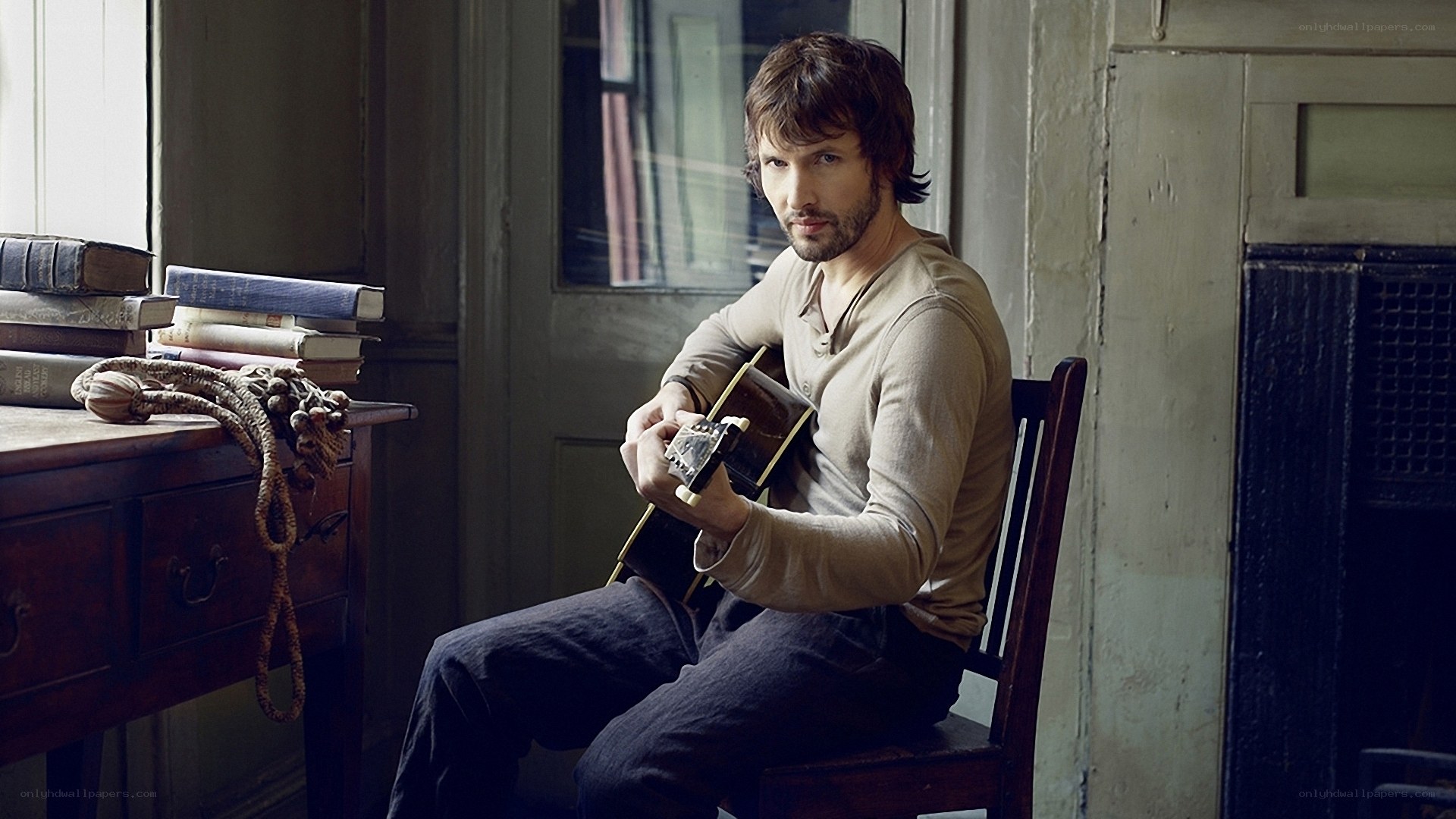 man holding acoustic guitar