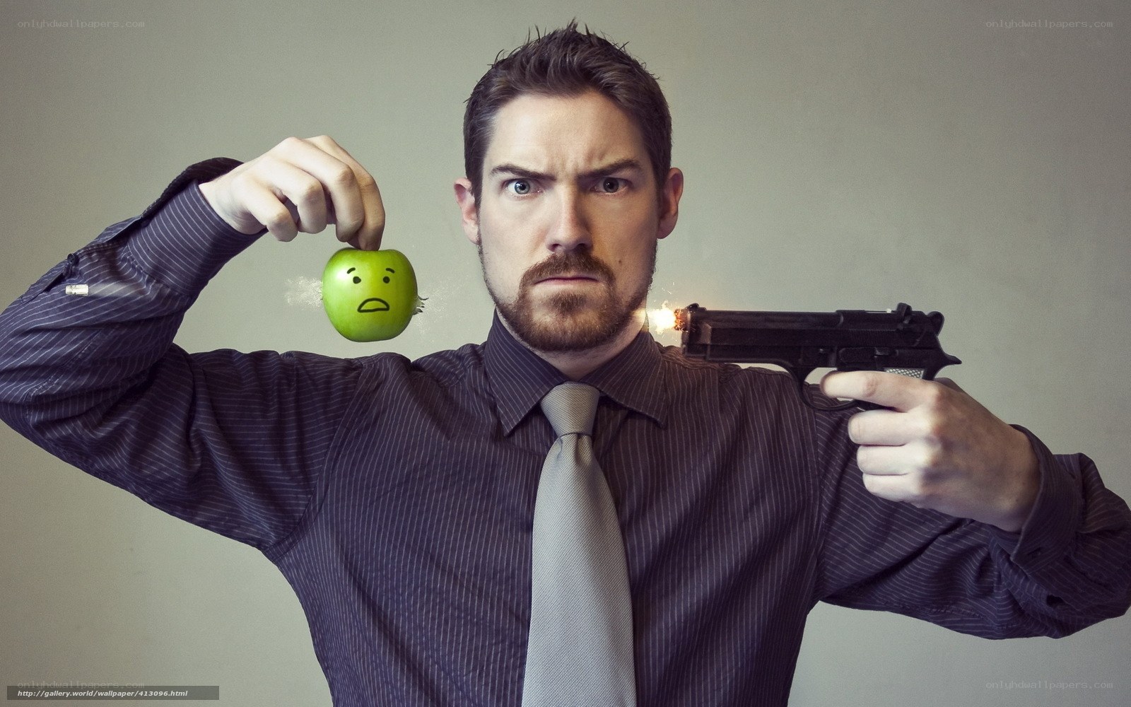 man holding apple and gun