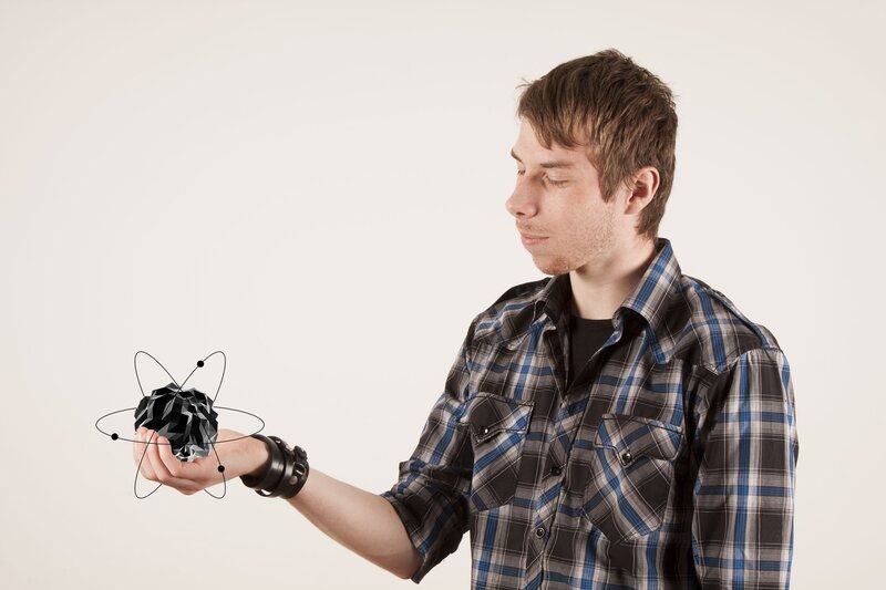 man holding atom model