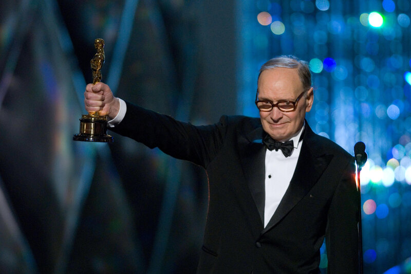 Man Holding Award — Black, Celebratory, Photograph, Tuxedo, Microphone