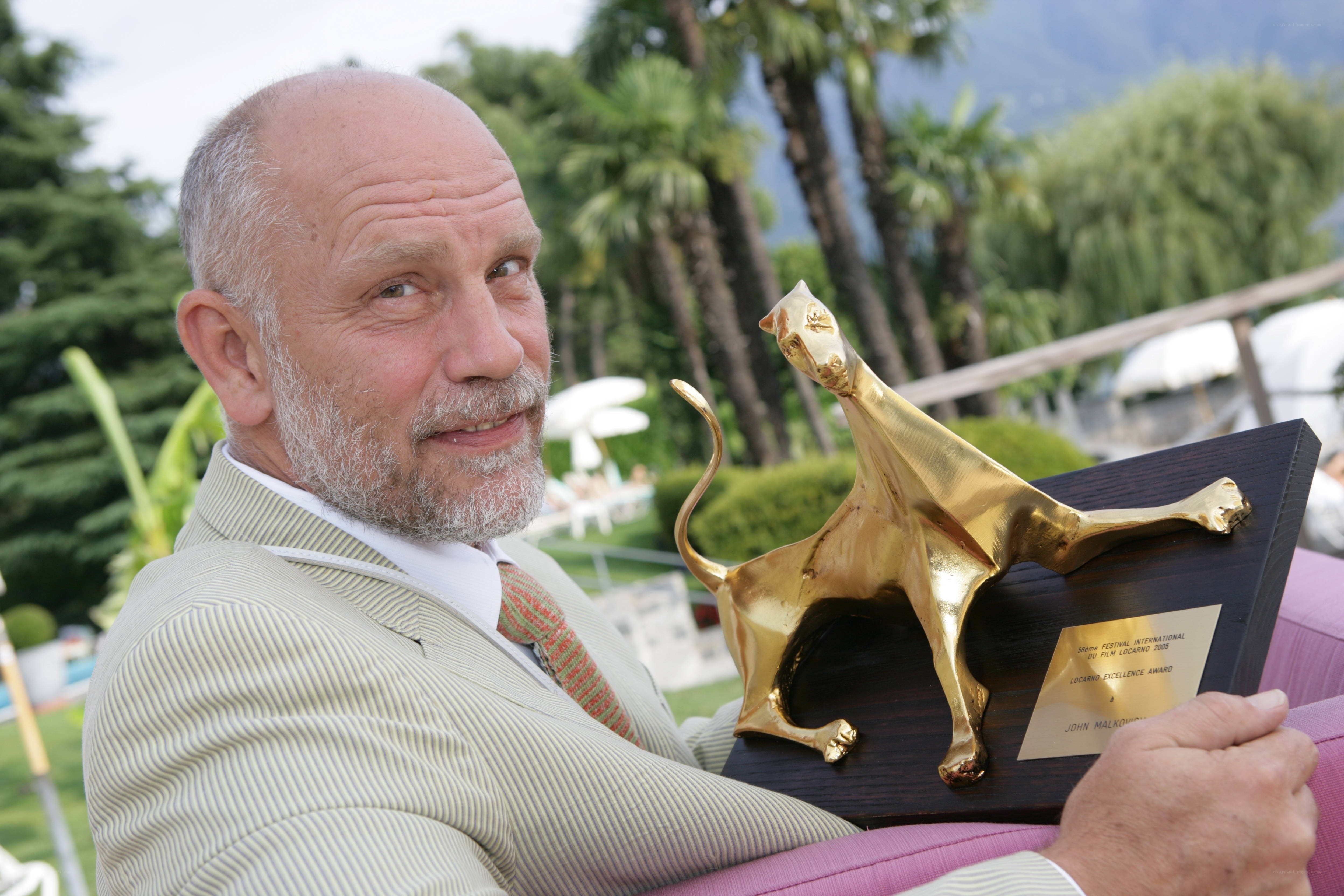 Man holding award outdoors