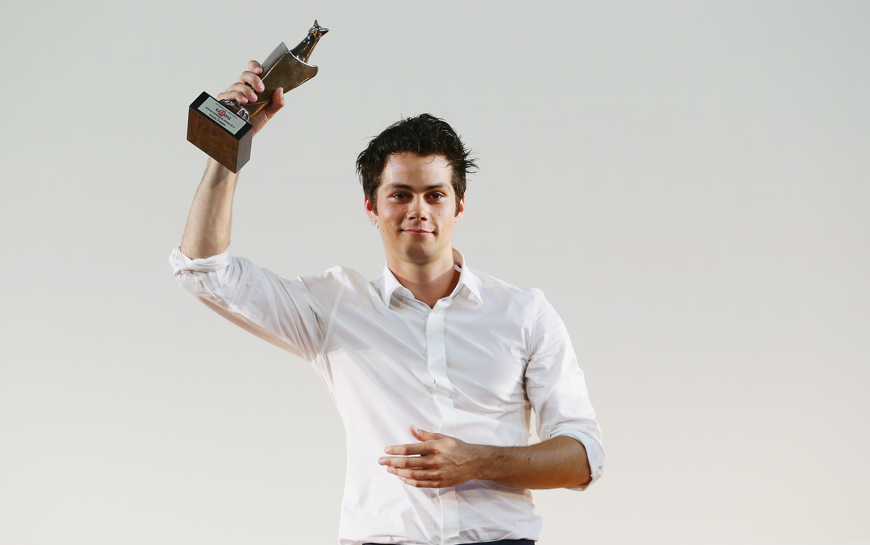 man holding award trophy