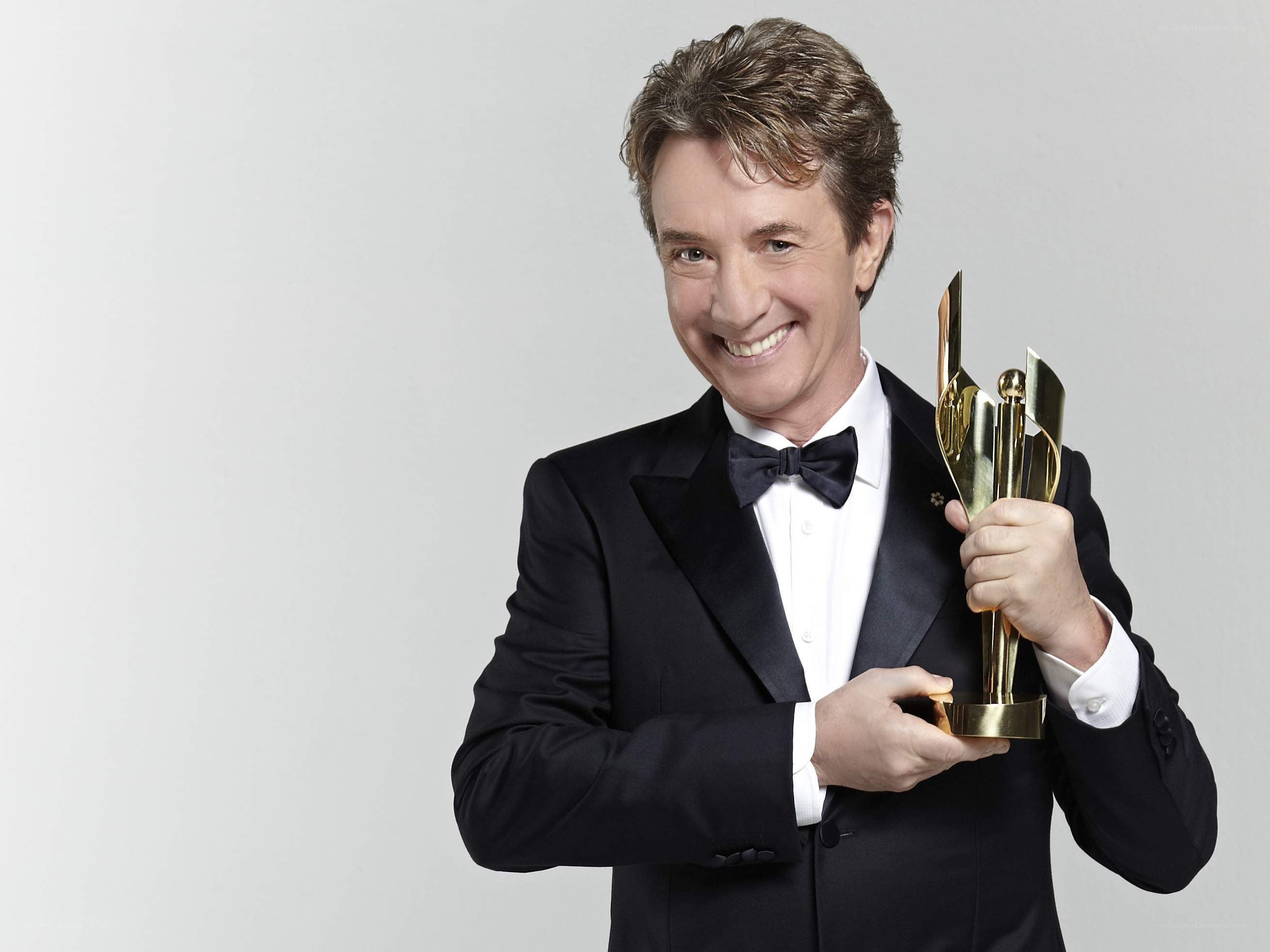 Man holding award trophy