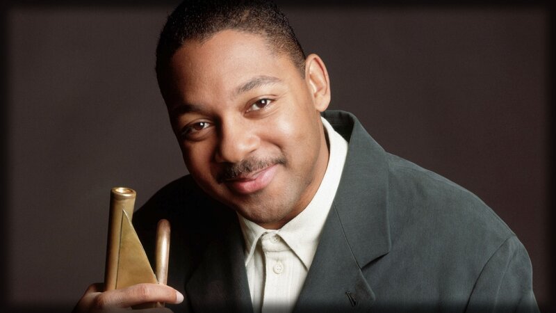 man holding award trophy