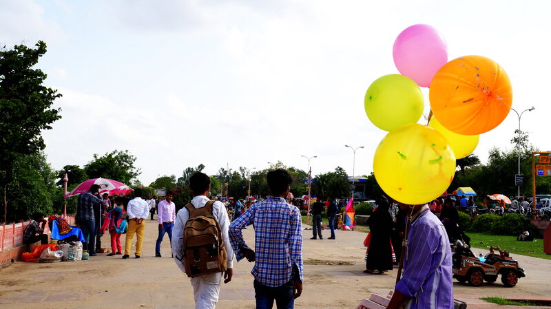 Man Holding Balloons — Yellow
