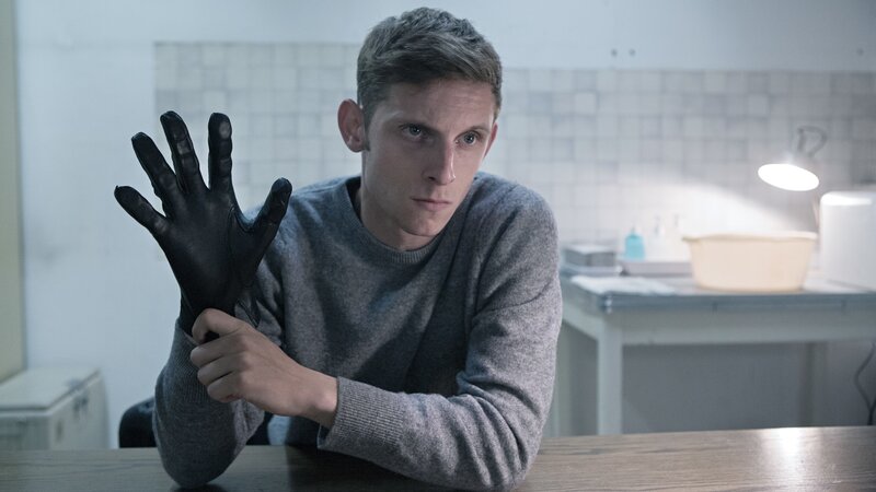 man holding black glove