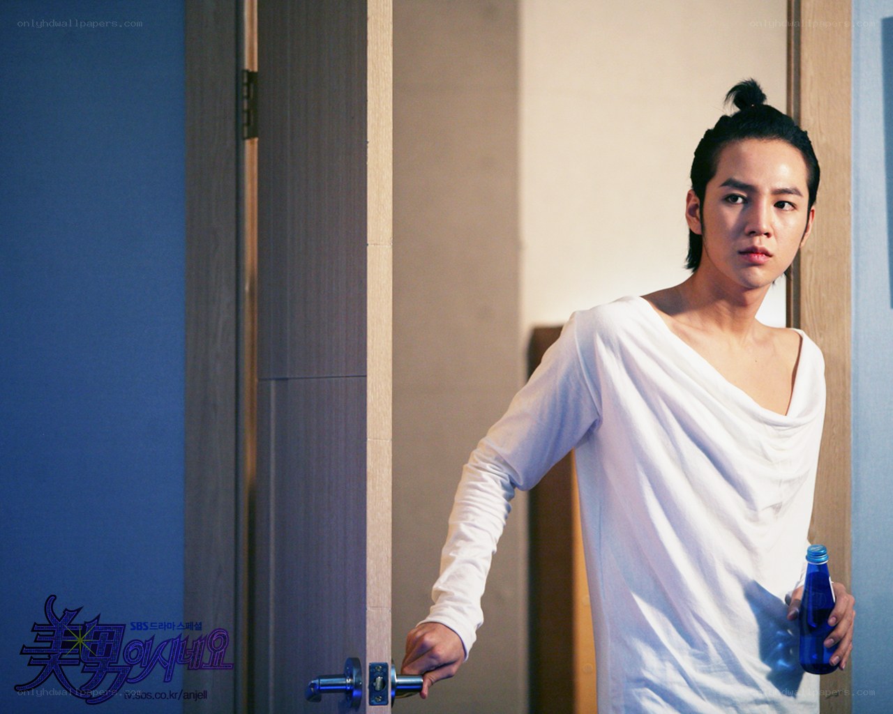 man holding bottle by door