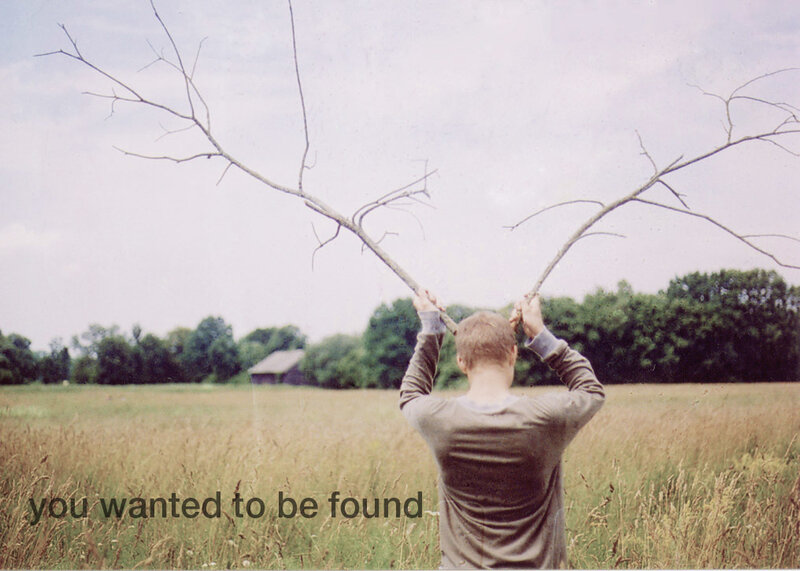 man holding branches in field