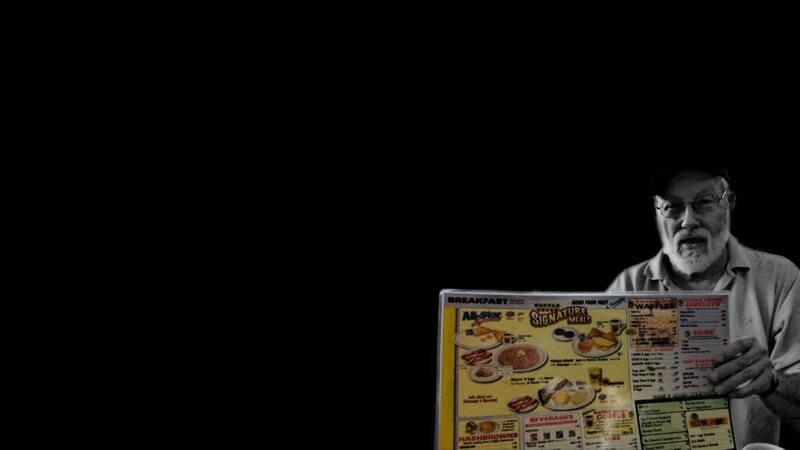 man holding breakfast menu