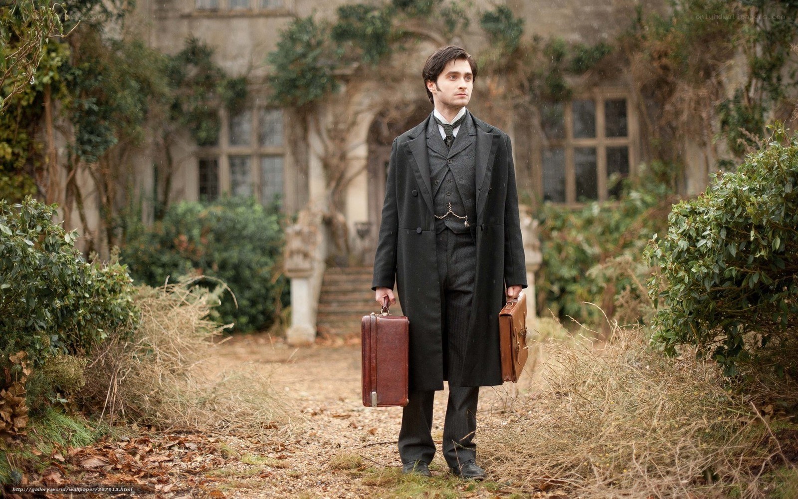 man holding briefcases in garden