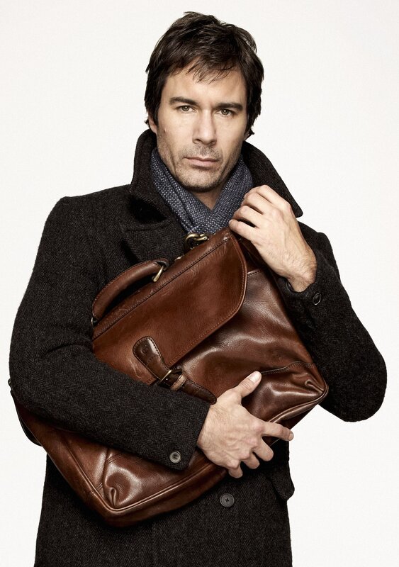 man holding brown leather bag