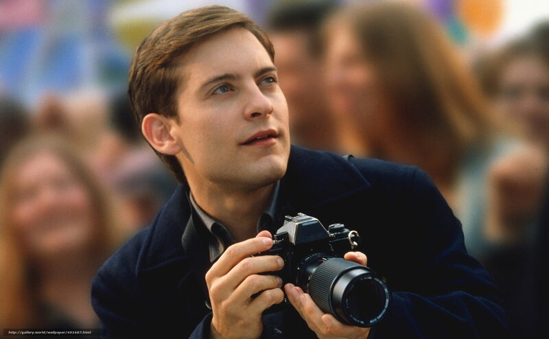 man holding camera in crowd