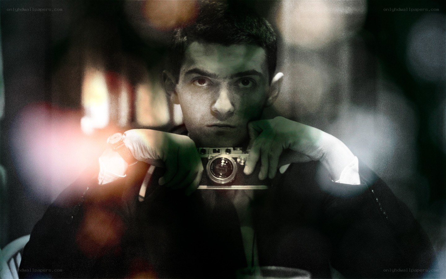 man holding camera in dark room