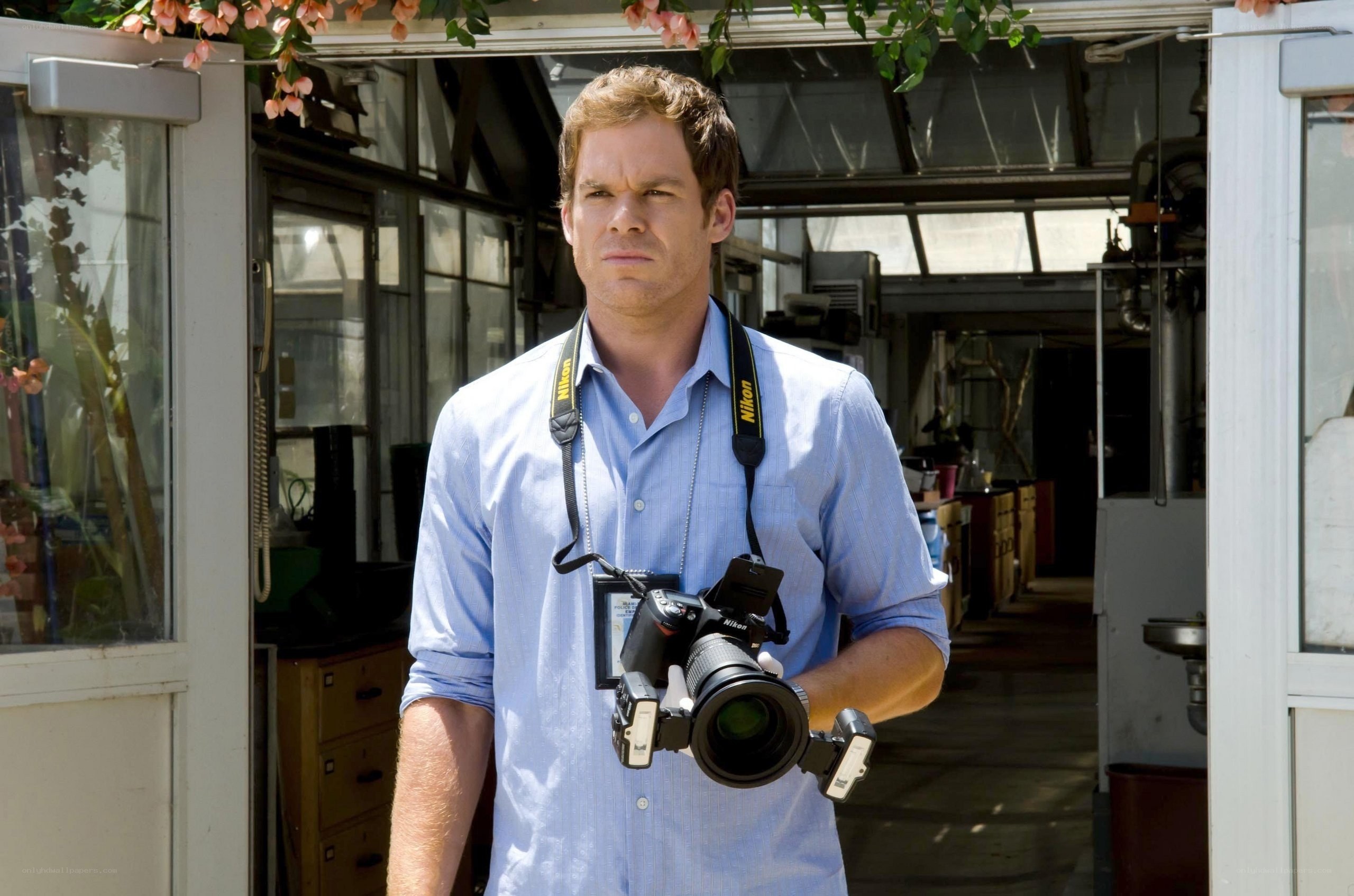 man holding camera in greenhouse