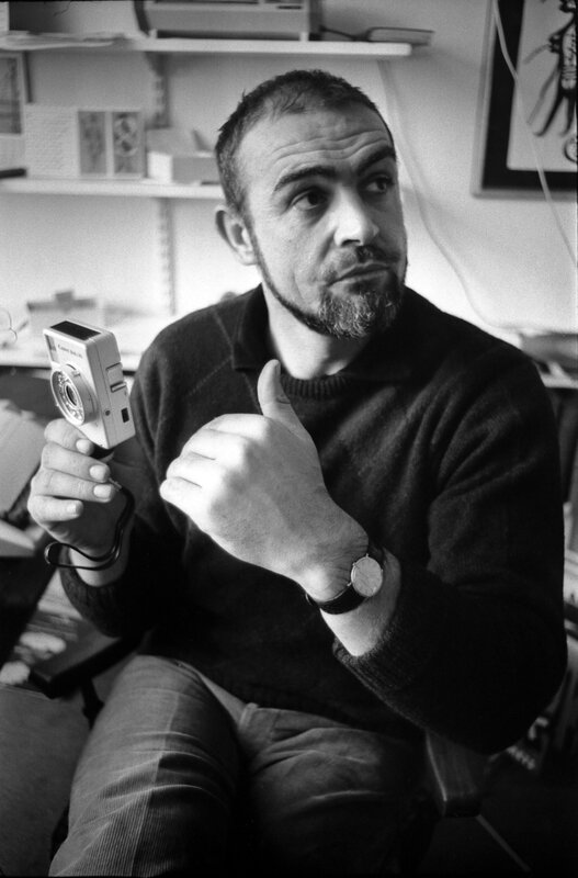 Man holding camera in studio
