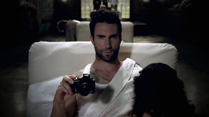 Man Holding Camera — White, Dramatic