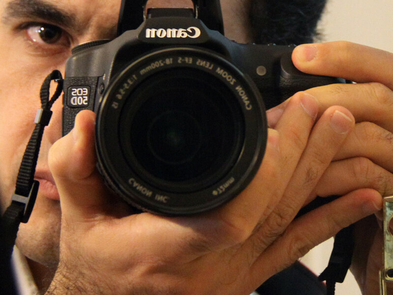 man holding canon camera