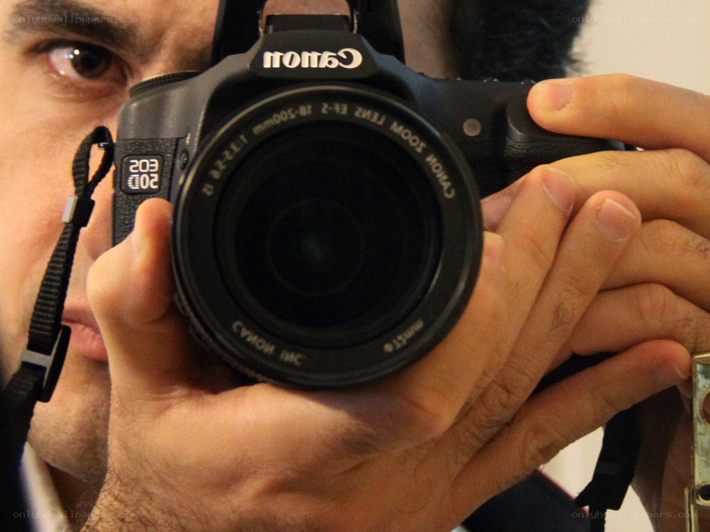 man holding canon camera