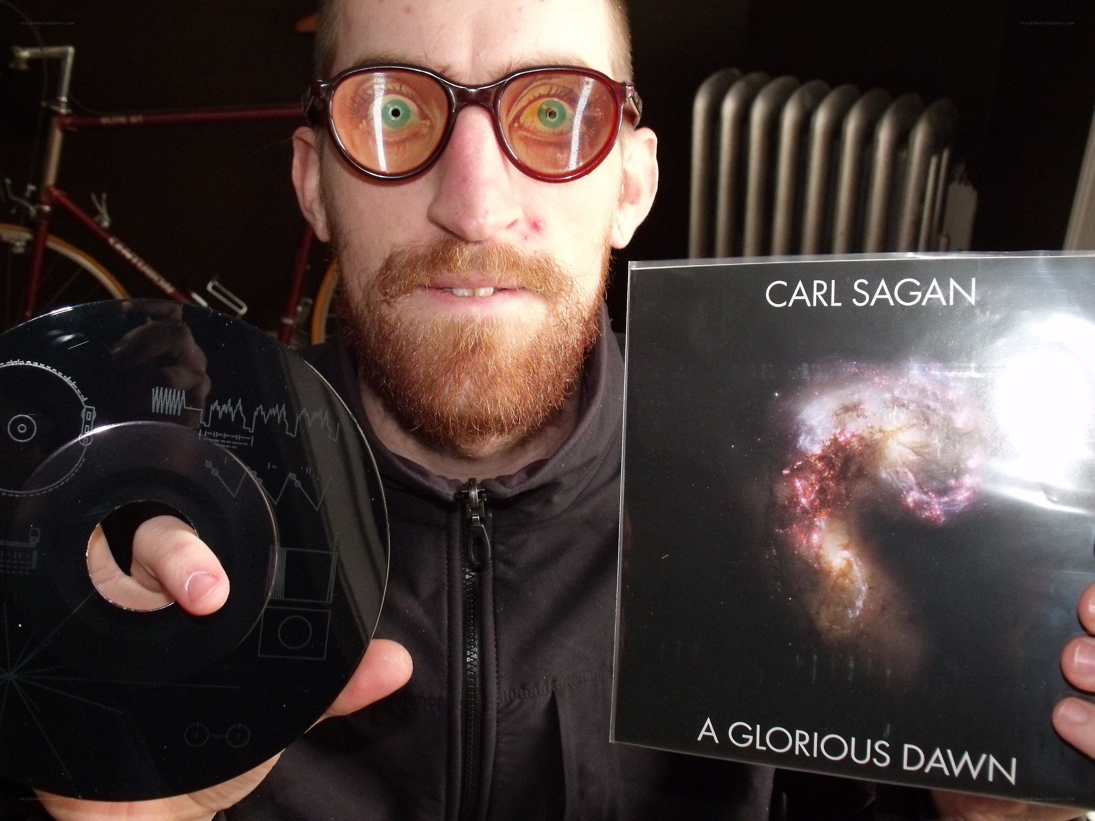 man holding cd and album