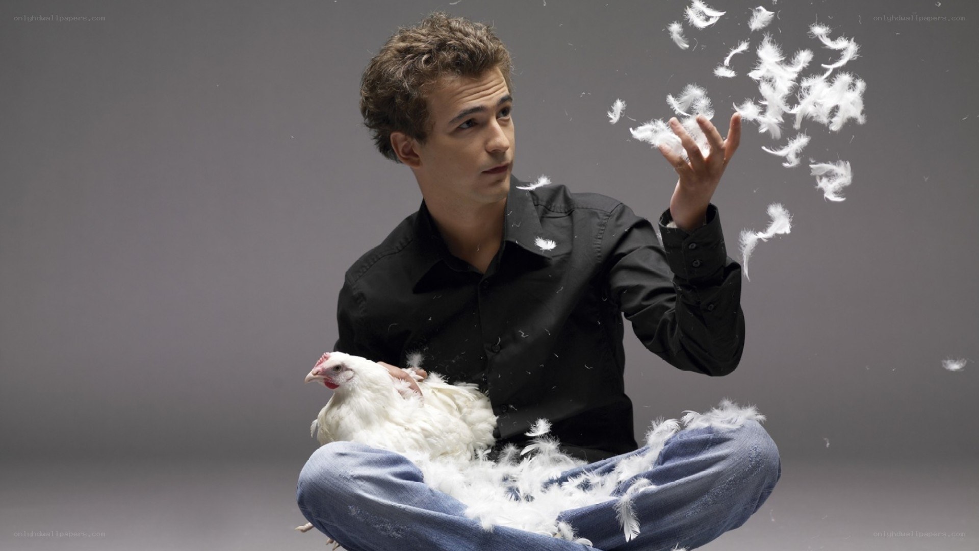 man holding chicken with feathers