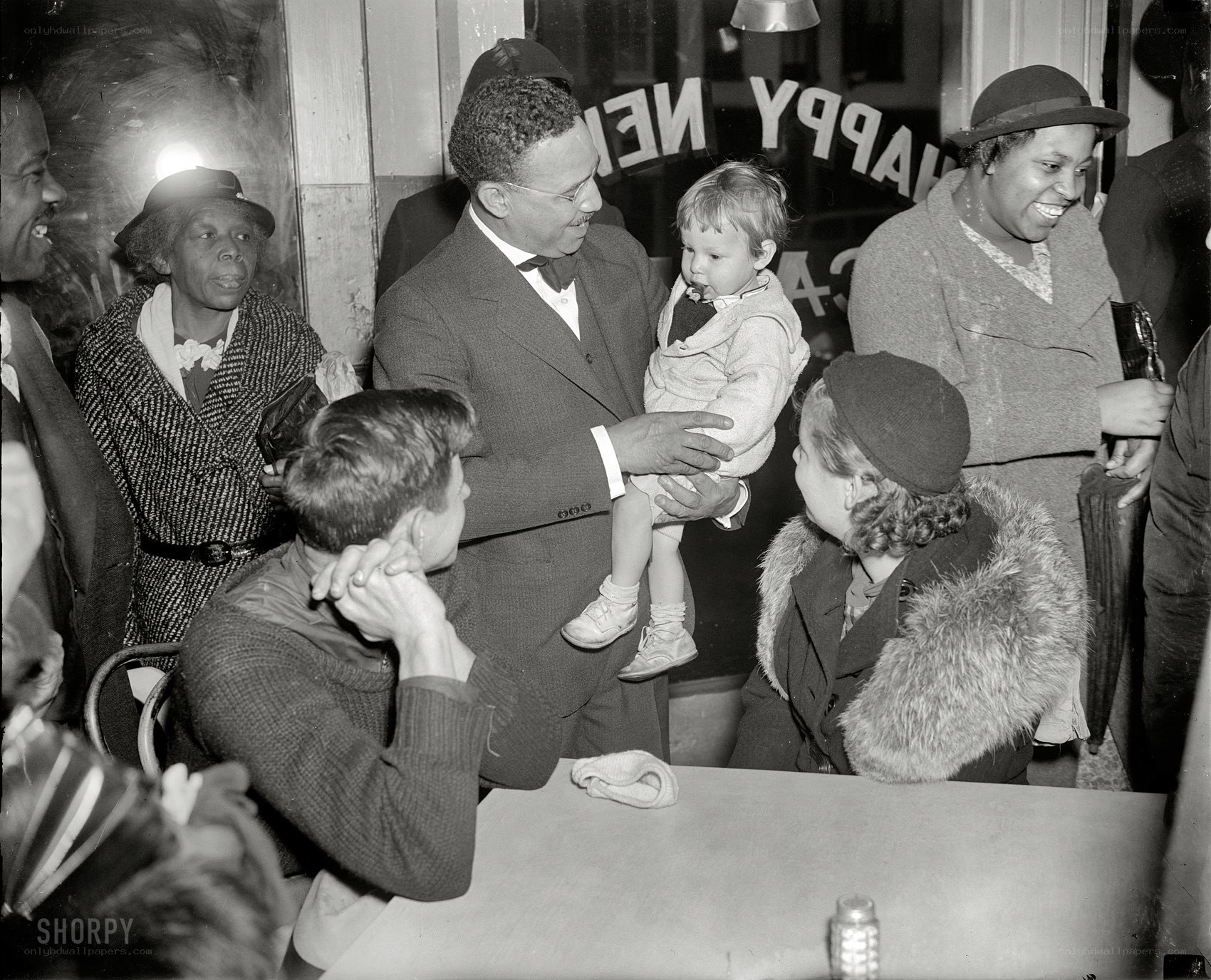 Man holding child in crowd
