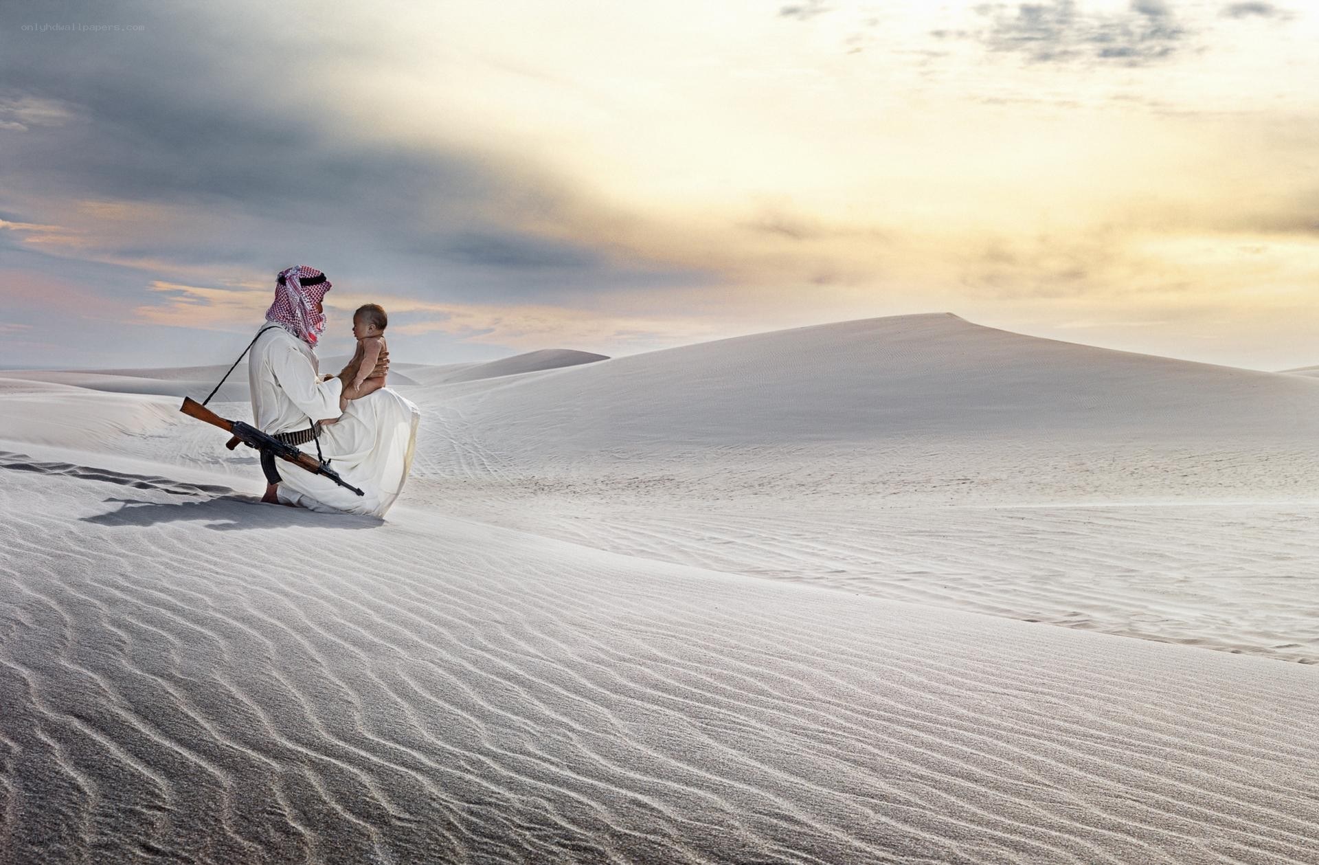 Man holding child in desert