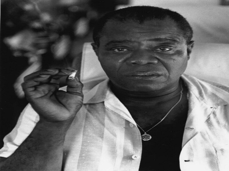 Man Holding Cigarette — Black, Serious