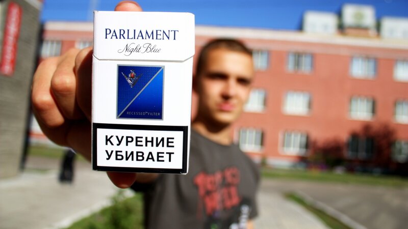 man holding cigarette pack