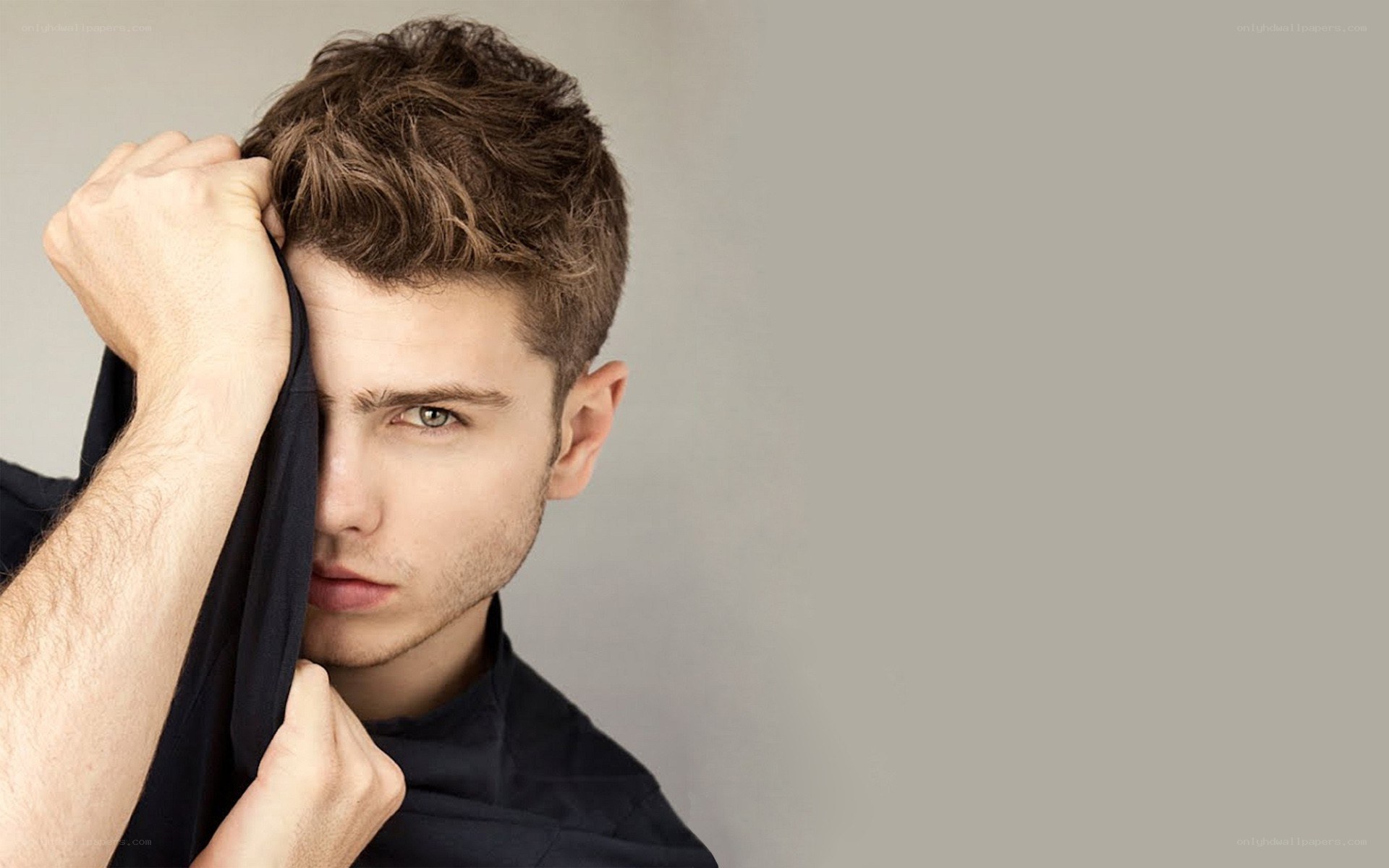 man holding cloth over face