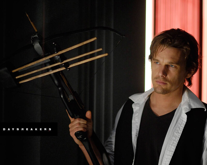 man holding crossbow in dark room