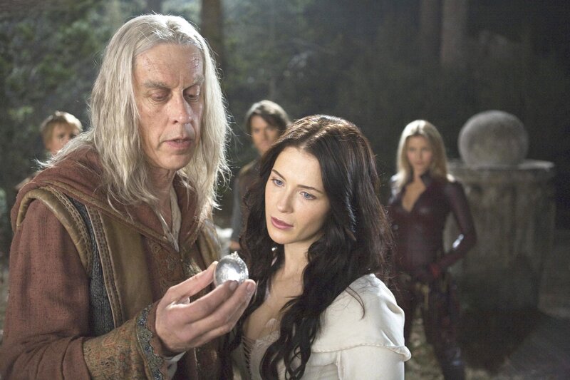 Man holding crystal orb with woman