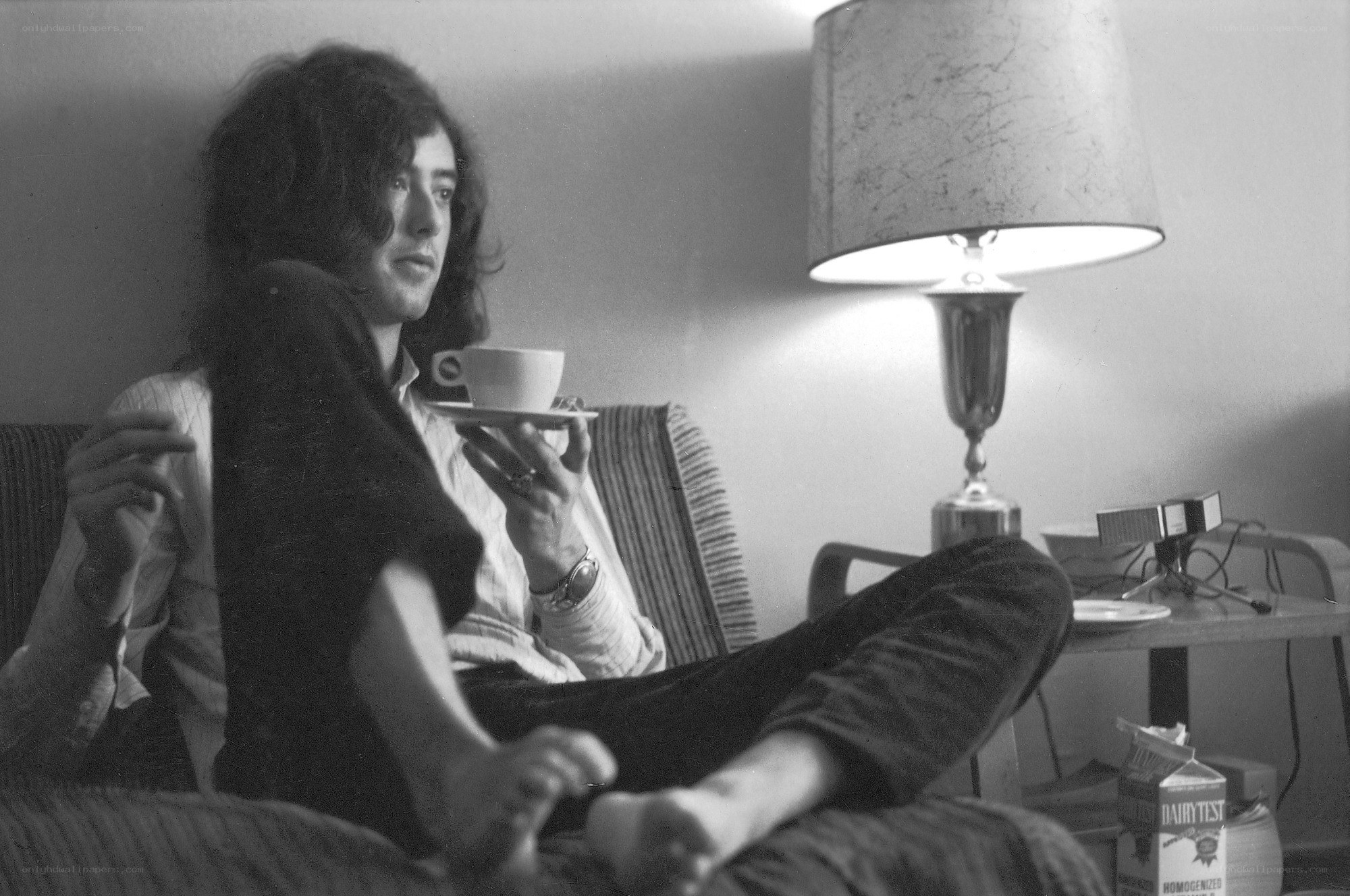 man holding cup on couch