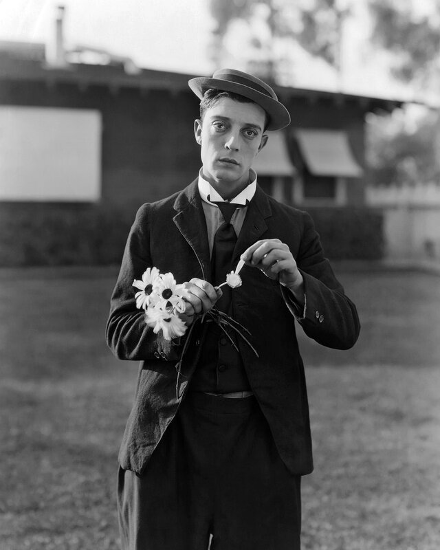Man holding daisies outdoors