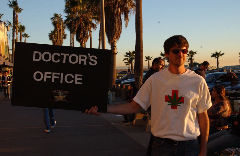Man holding doctor's office sign