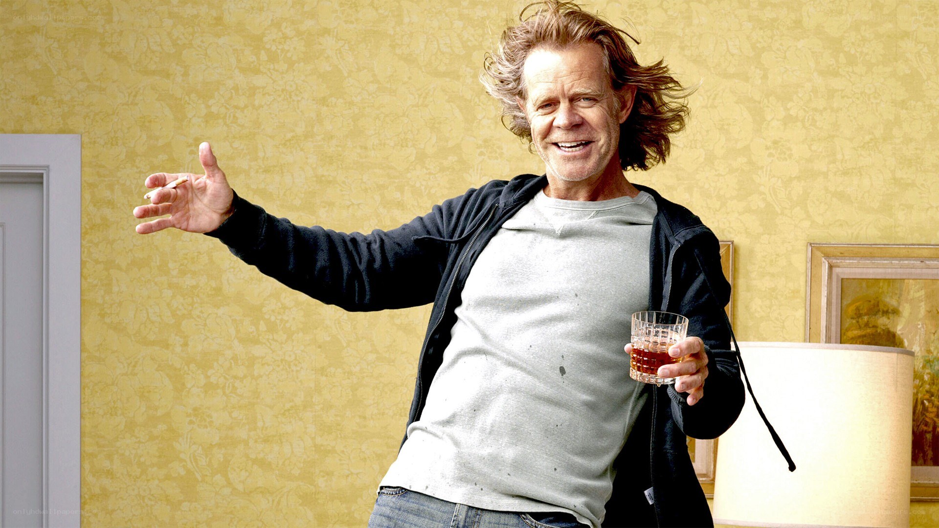 man holding drink and cigarette