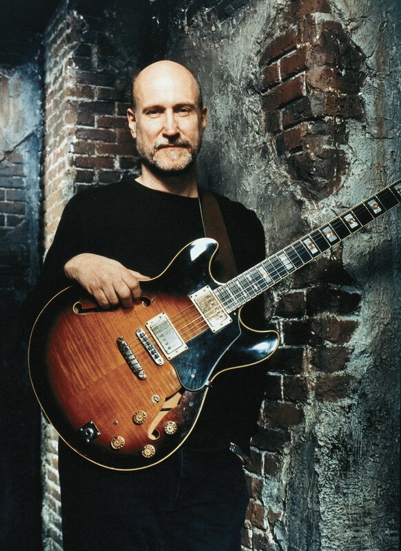 man holding electric guitar
