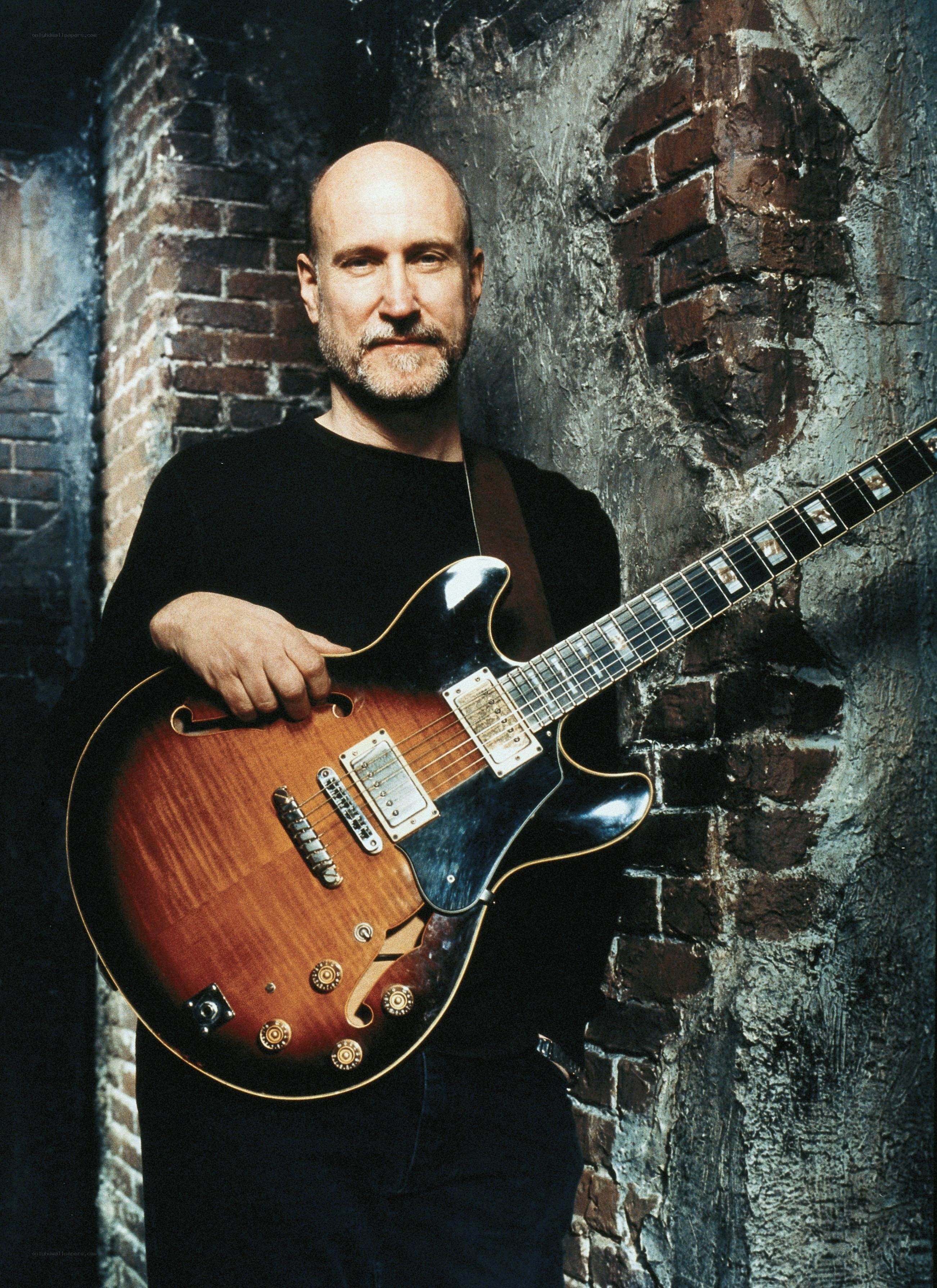 man holding electric guitar
