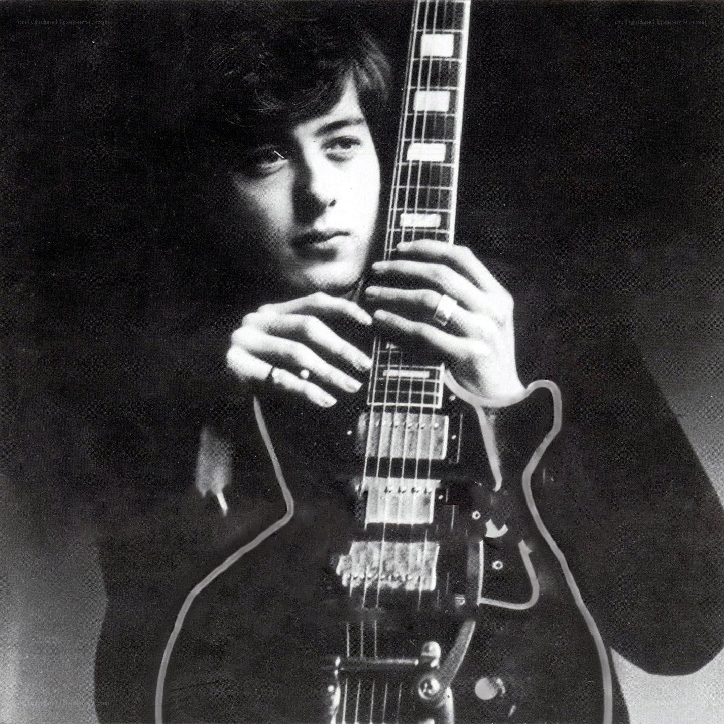 man holding electric guitar