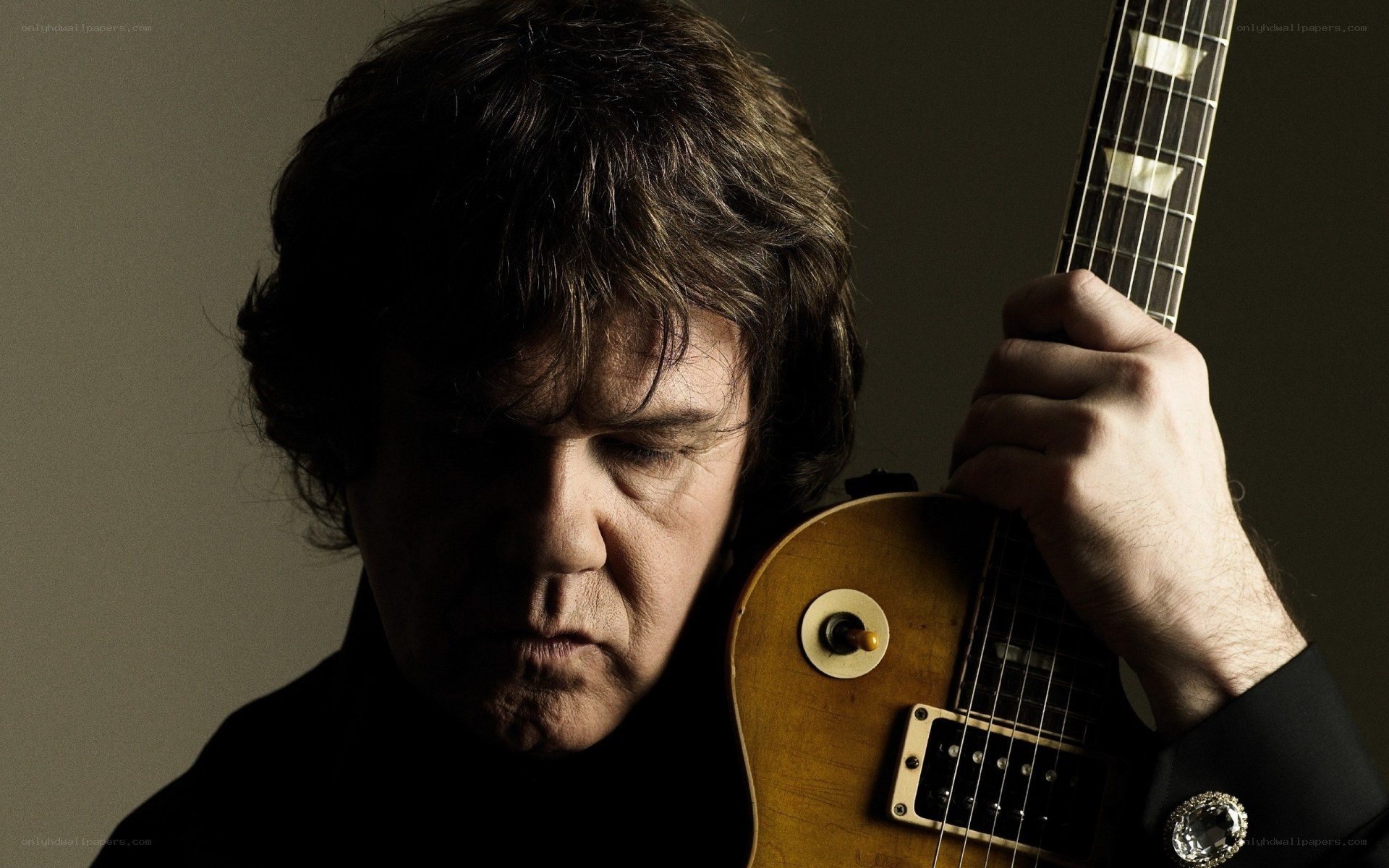 man holding electric guitar